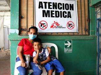 Yamilex, a migrant in Tumbes, Peru, with her son.