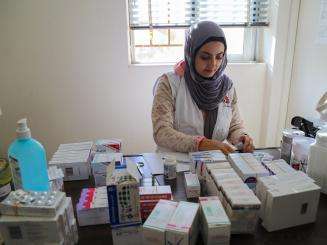 A member of MSF's medical mobile team in Nabatiyeh, south of Lebanon sorts through medicine stock.