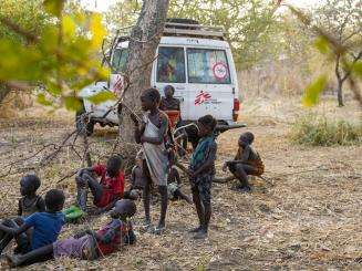 A group of children beside an MSF vehicle during health outreach activities in Boma, South Sudan.
