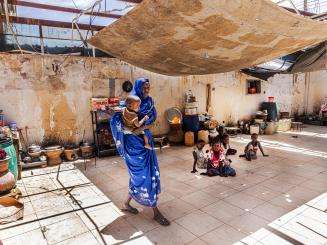 A displaced woman holding her child in Zalingei city, capital of Central Darfur state, Sudan.