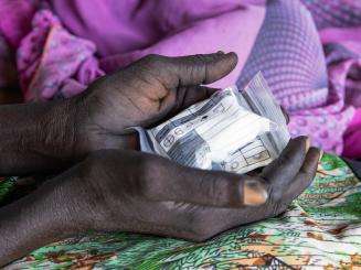 An HIV/TB patient holds medication in South Sudan. 