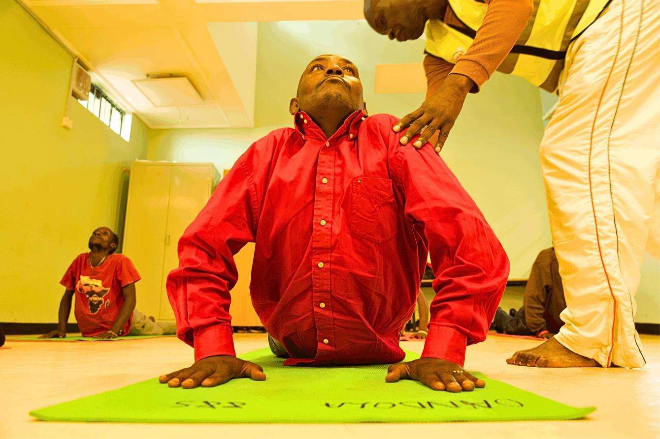 A patient is instructed during a Yoga Session in Karuri MAT clinic, Kiambu Kenya.