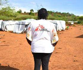 Nancy Mutai, a psychologist, looking at Moinonin camp in Kenya.